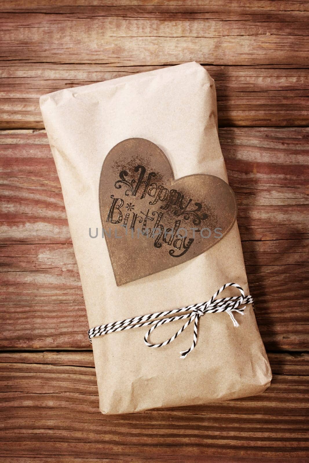 Hand crafted happy birthday present box on rustic wooden boards
