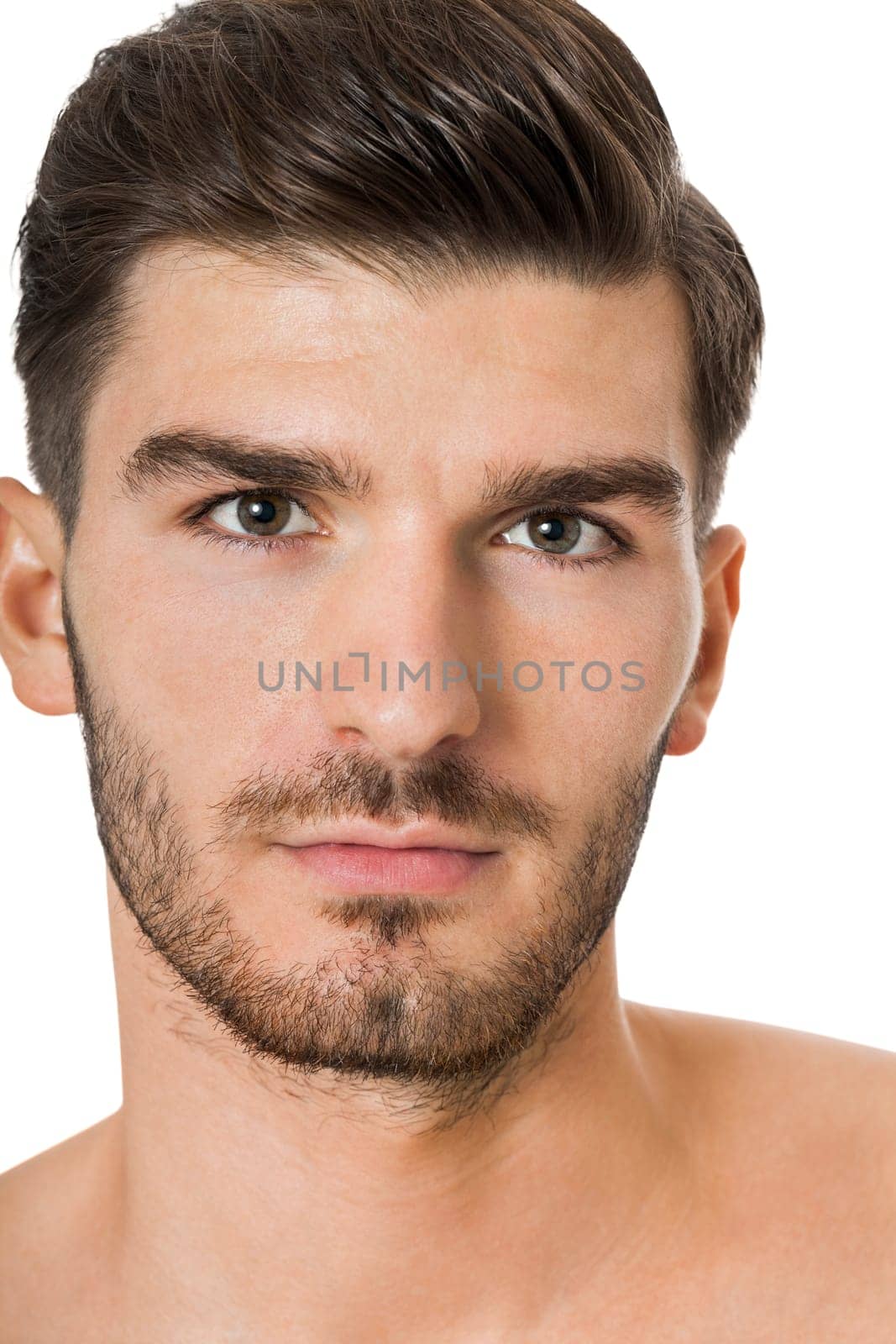 attractive muscular young man with free torso and beard isolated against white background