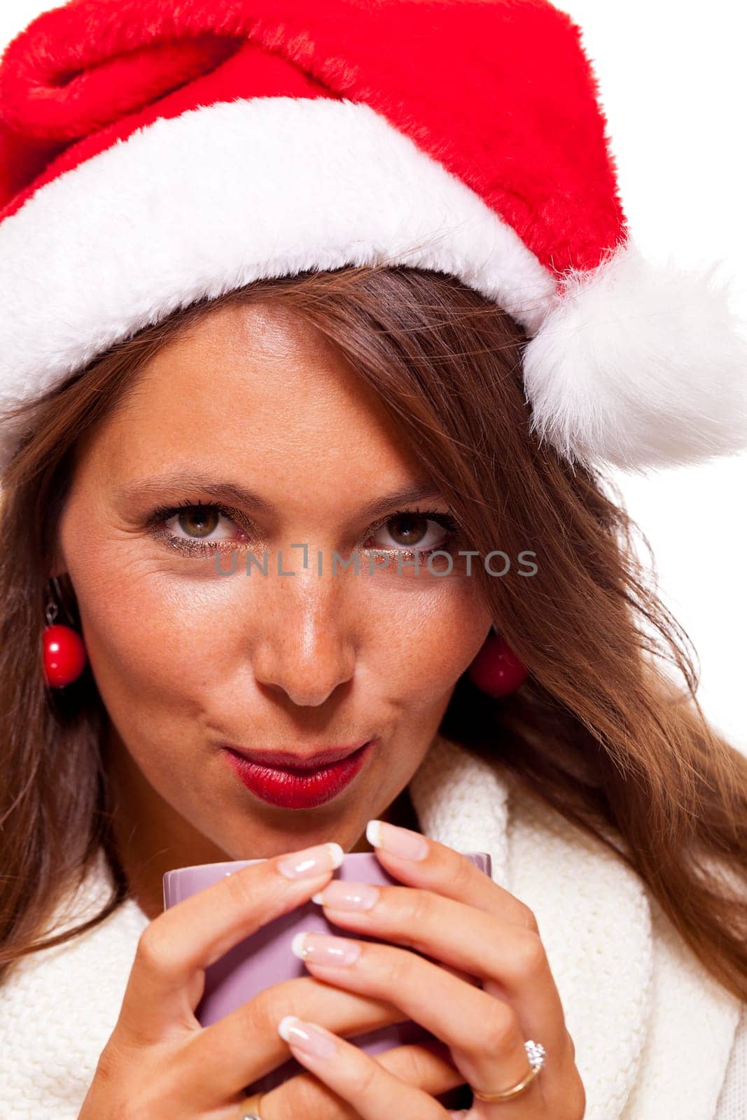 Attractive young woman with red Santa hat drinks a hot cup of coffee she weighs in her hands to warm her hands Insulated freeagent