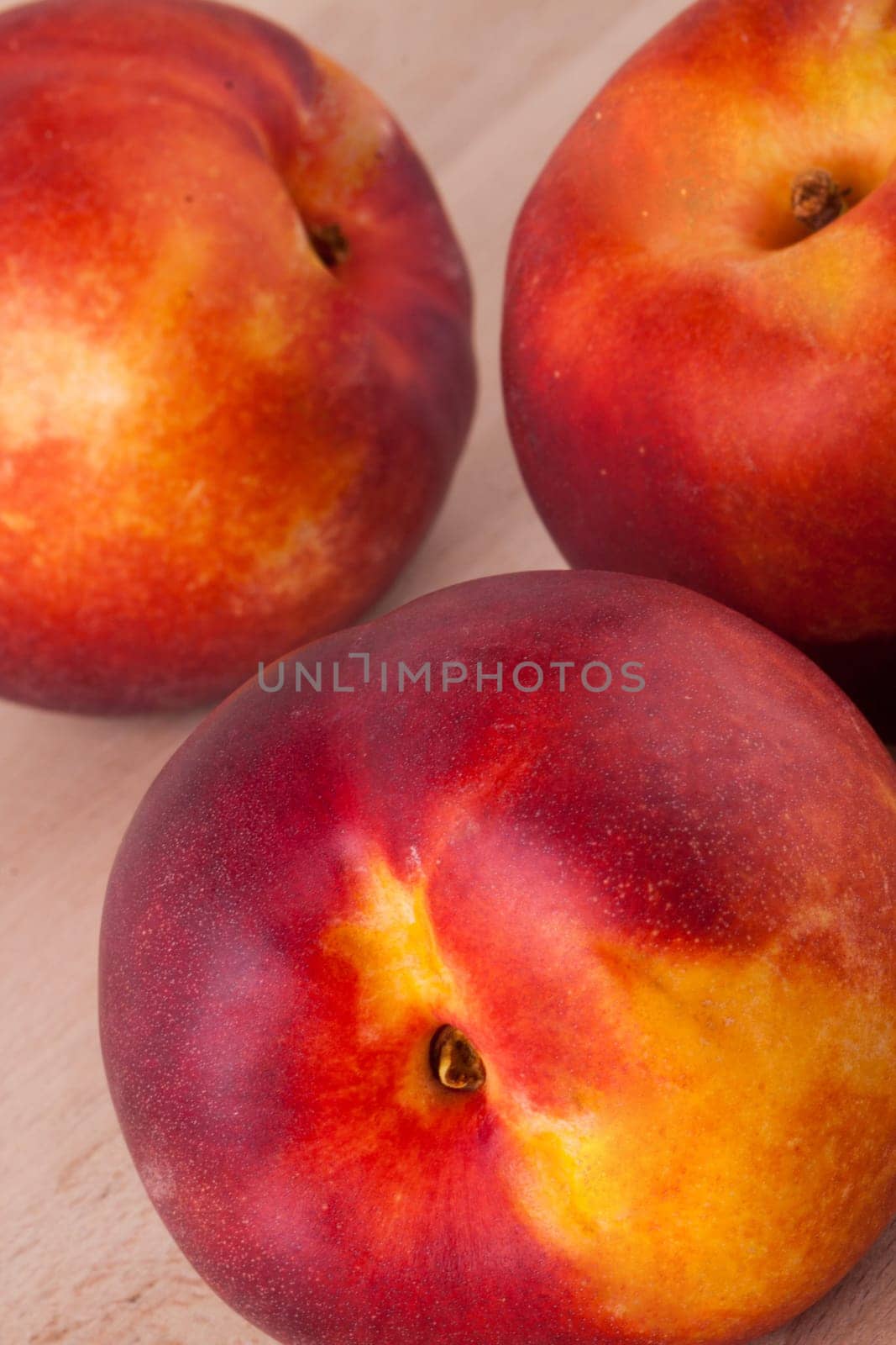 Fresh nectarines,oranges,peaches close-up on white background