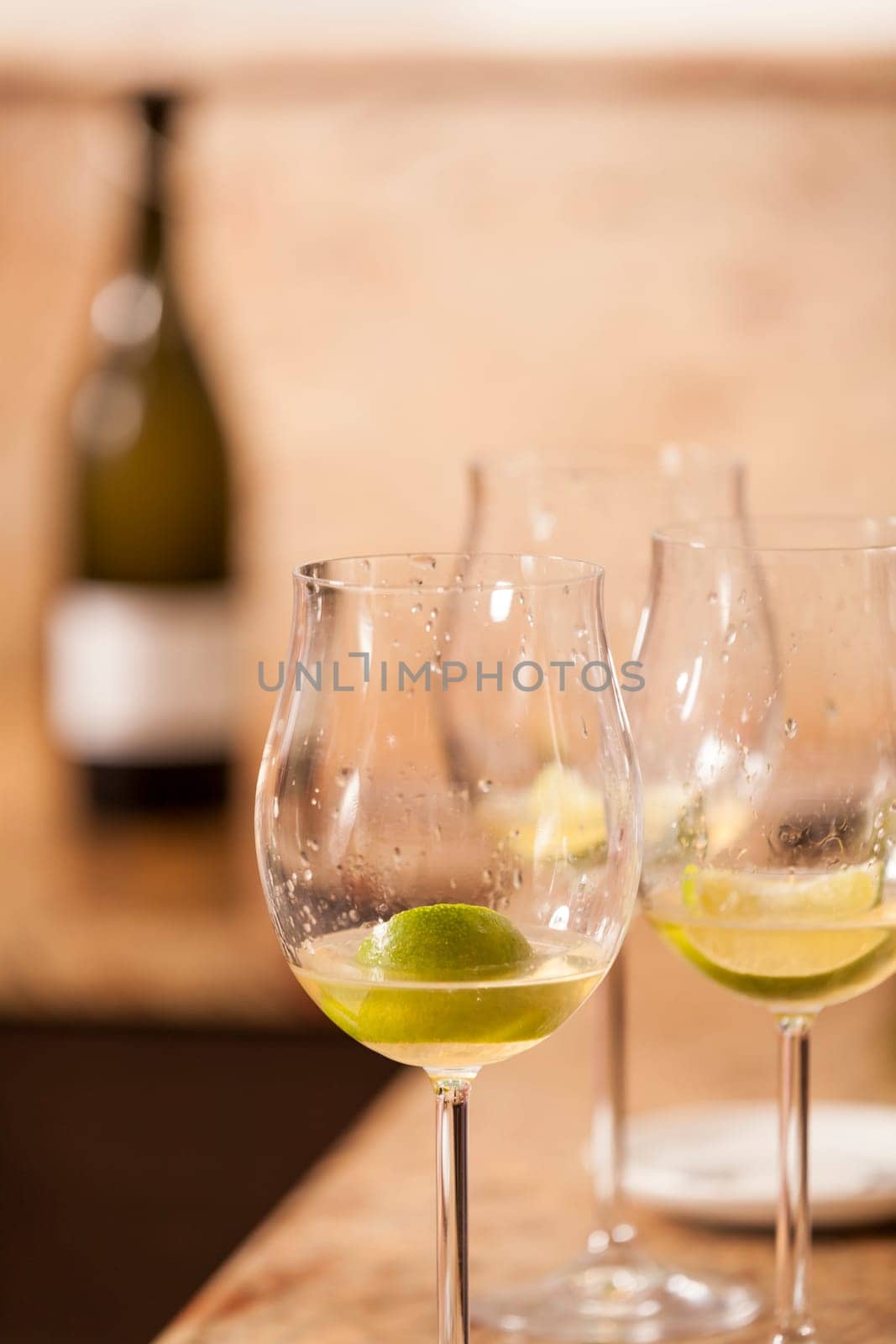Sparkling wine bottle with wine glasses for an aperitif in a kitchen