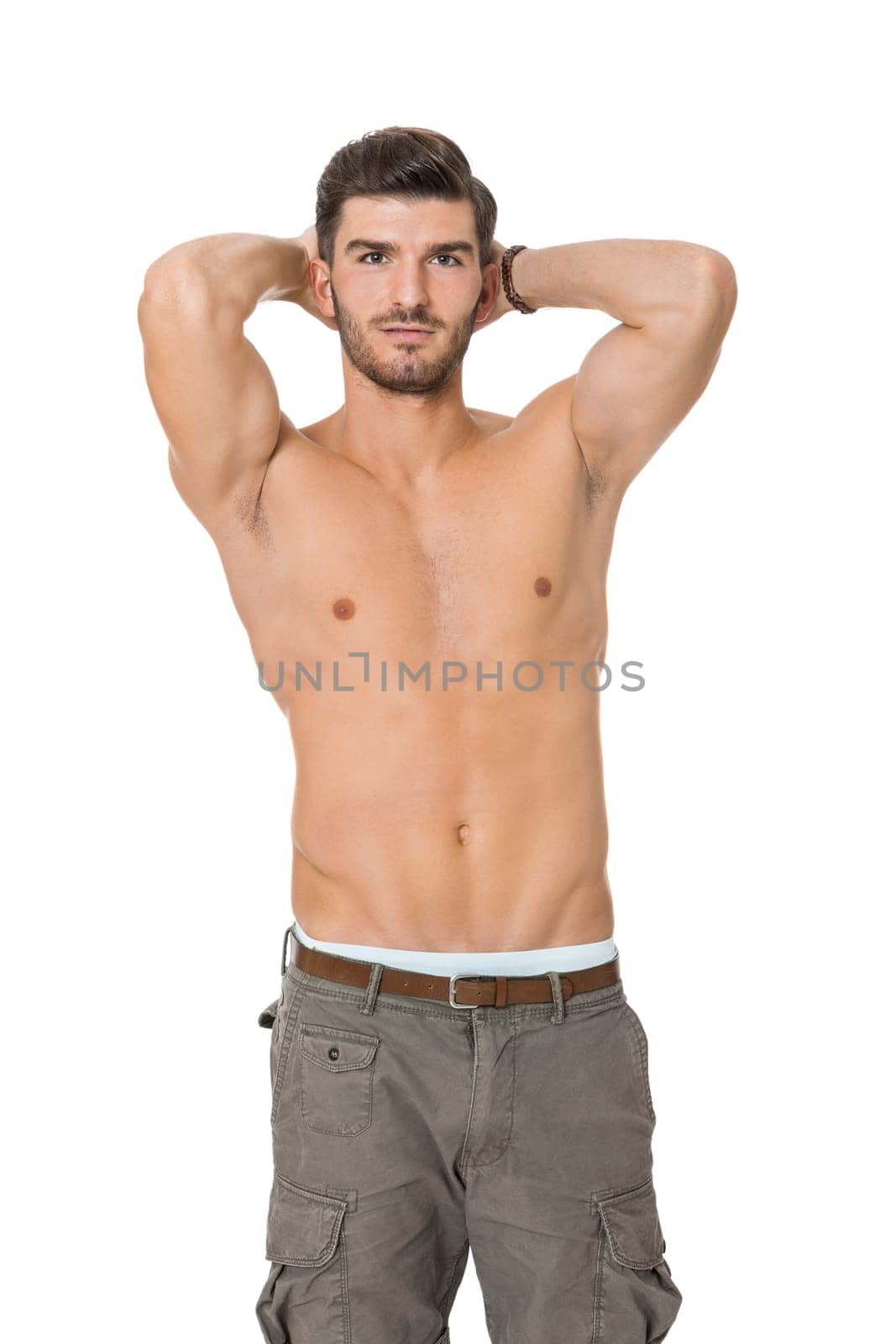 attractive muscular young man with free torso and beard isolated against white background