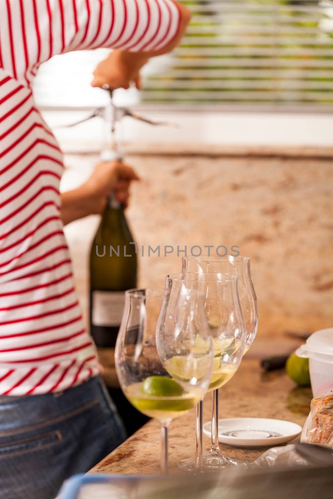 Sparkling wine bottle with wine glasses for an aperitif in a kitchen