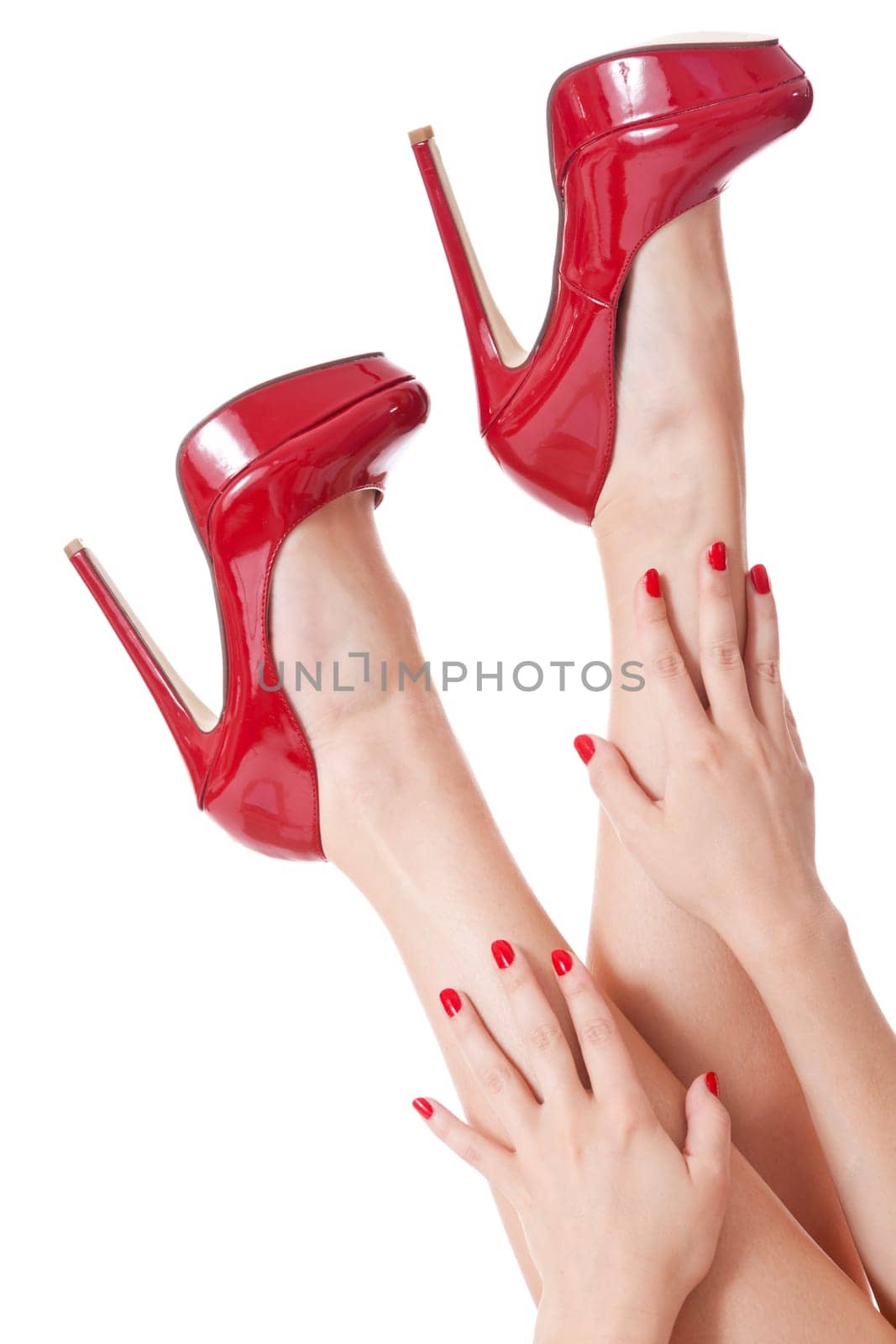 Close-up name of hands with red fingernails and feet with red stilettos isolated against white background