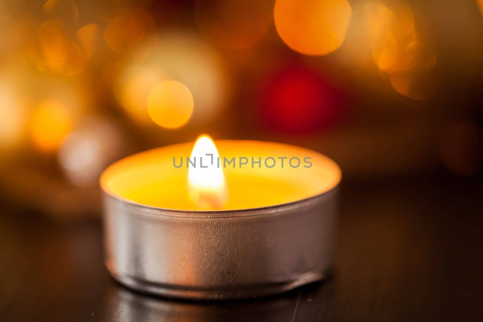 Warm golden and orange Christmas decoration with candlelight as close-up in context