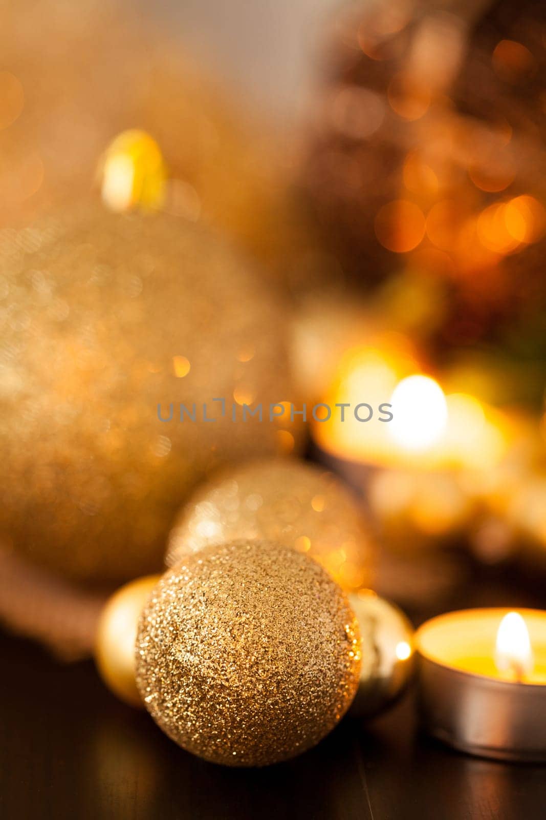 Warm golden and orange Christmas decoration with candlelight as close-up in context