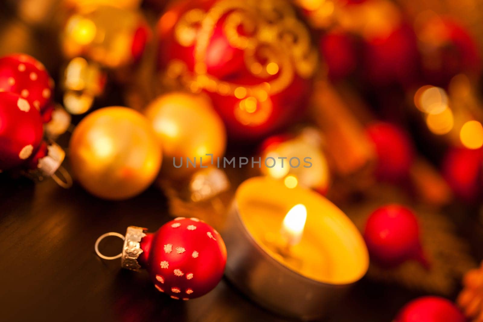 Warm golden and orange Christmas decoration with candlelight as close-up in context