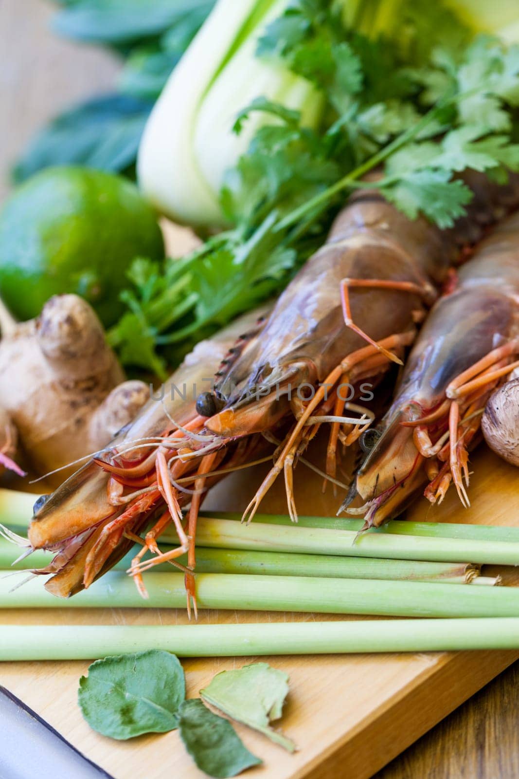 Ingredients for Tom Yam soup with lemongrass shrimp coriander on a kitchen board