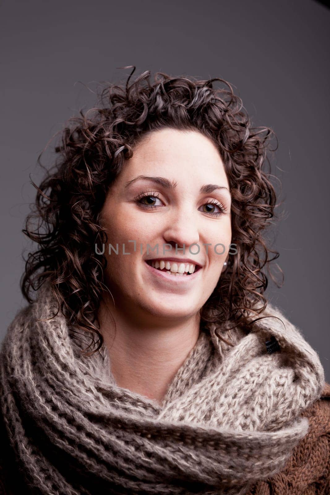 this smiling girl is ready for winter because she's self confident and smiling and have a good scarf