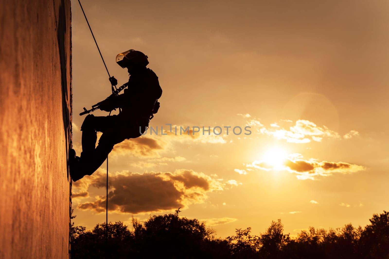 Silhouette of police officer during rope exercises with weapons