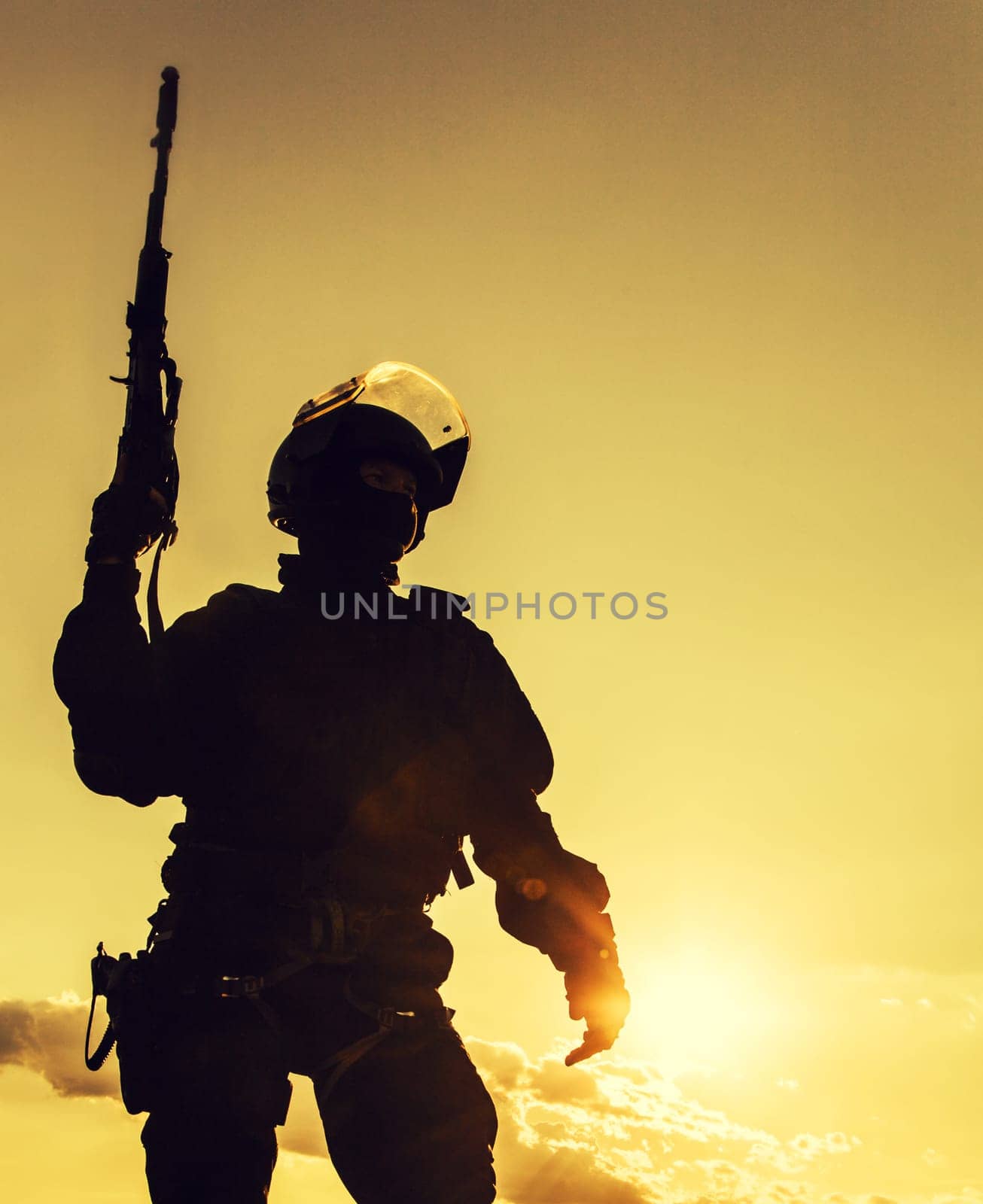 Silhouette of police officer with weapons at sunset