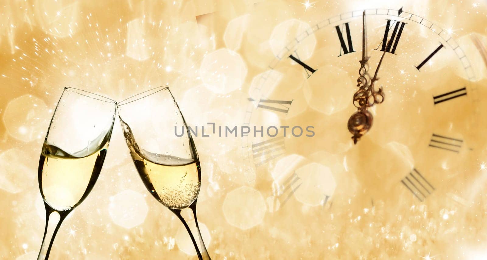 Glasses with champagne against holiday lights and clock close to midnight