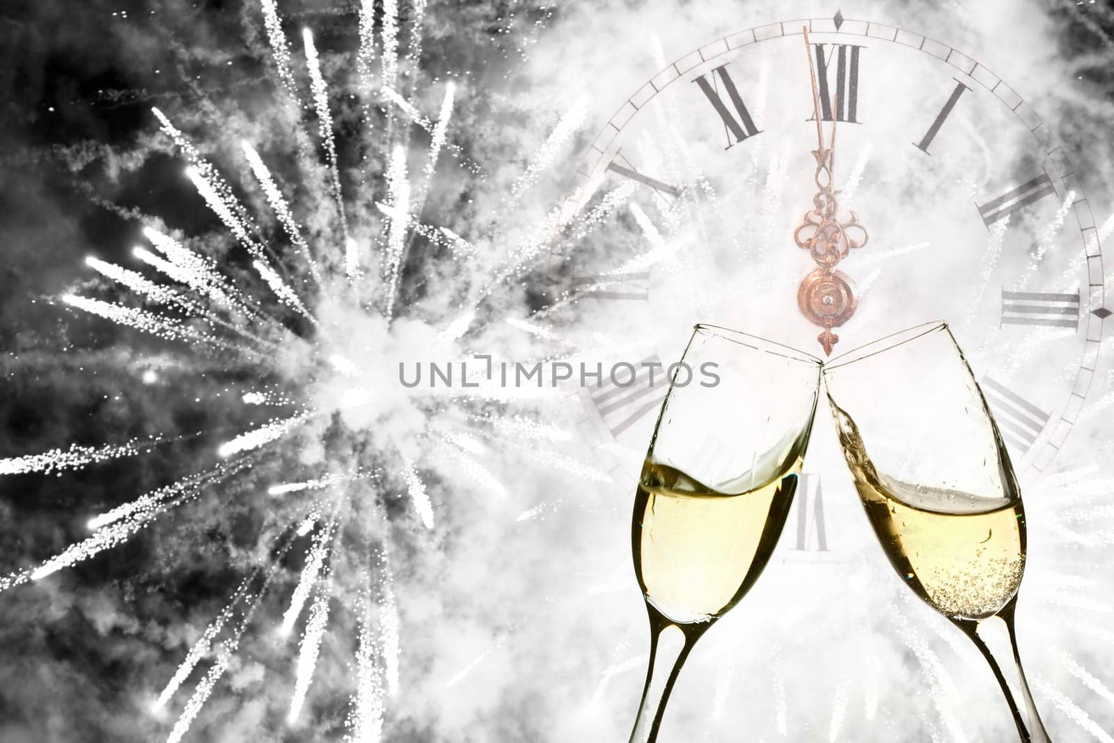 Glasses with champagne against holiday lights and clock close to midnight