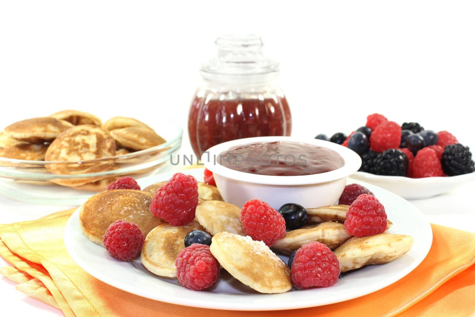 baked poffertjes with raspberries and blueberries