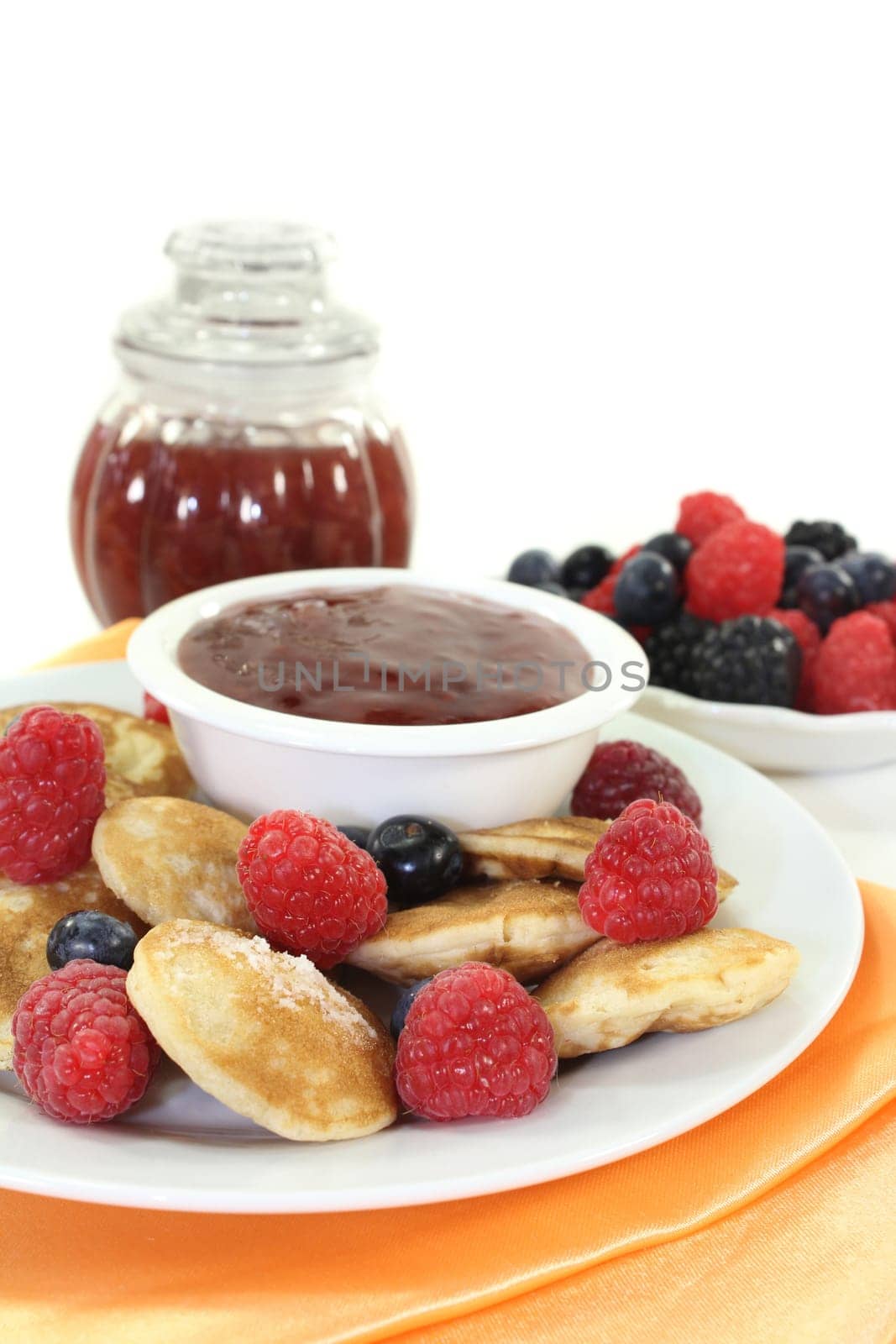 baked poffertjes with raspberries and blueberries