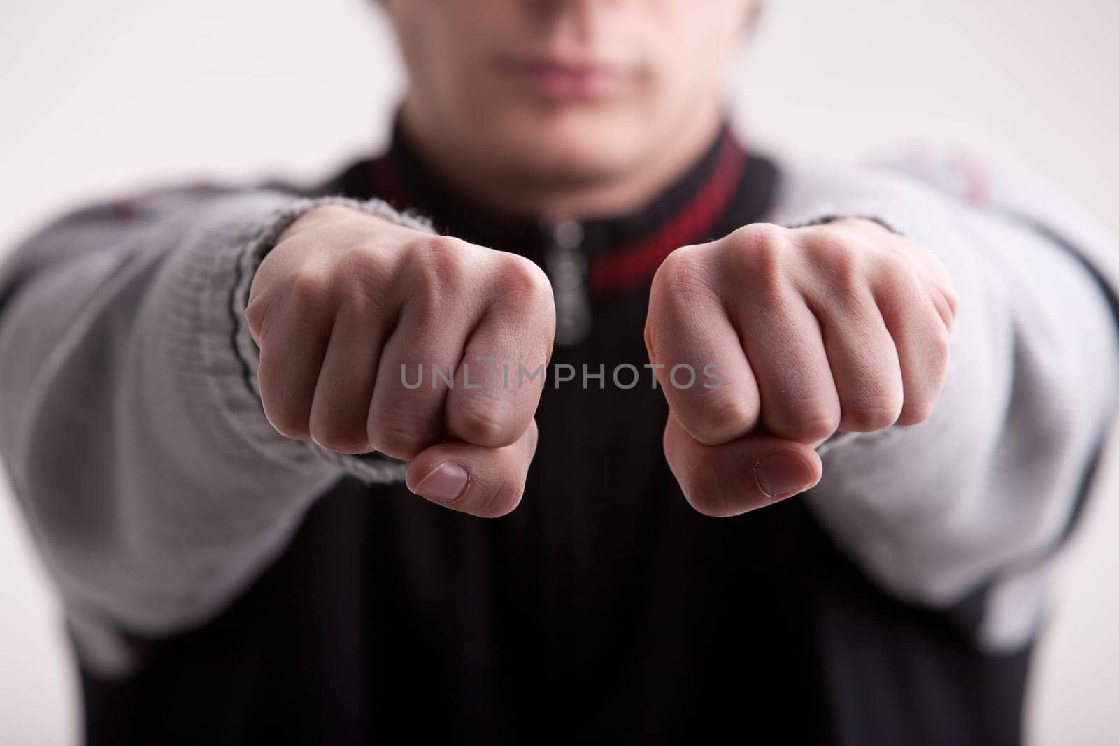 guy with fists pushed out in the air hiding something