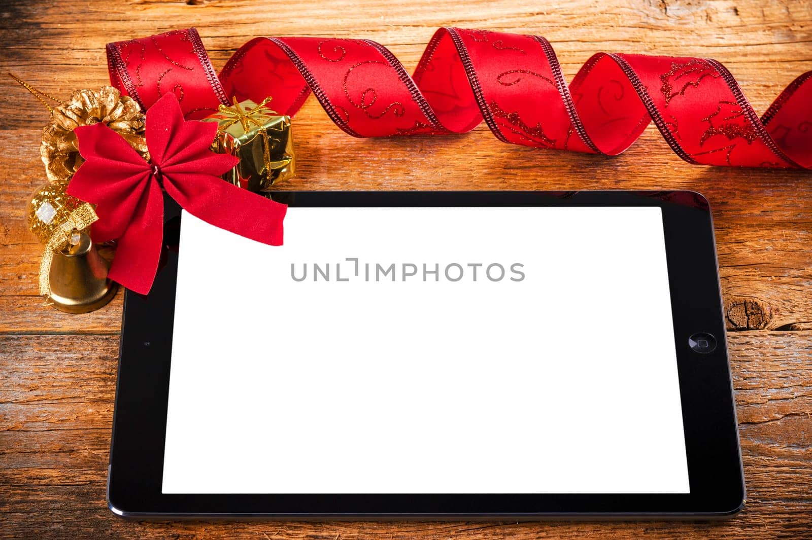 tablet pc with christmas decorations on wooden background