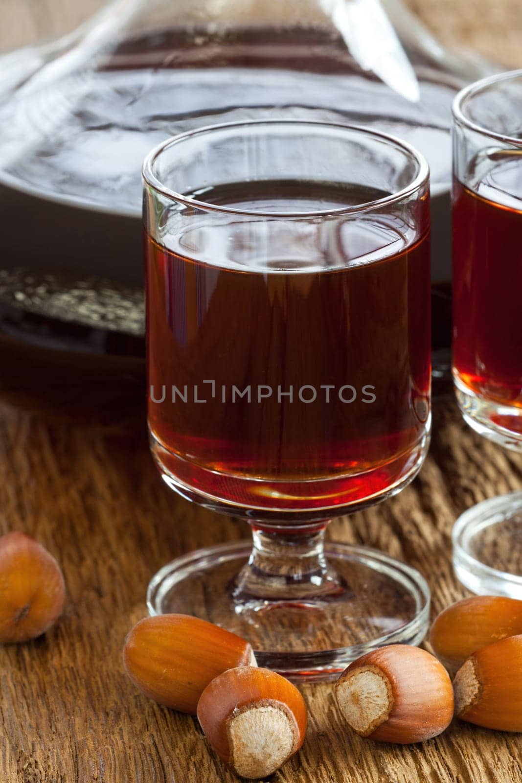 Homemade hazelnut liqueur in a carafe and a glass