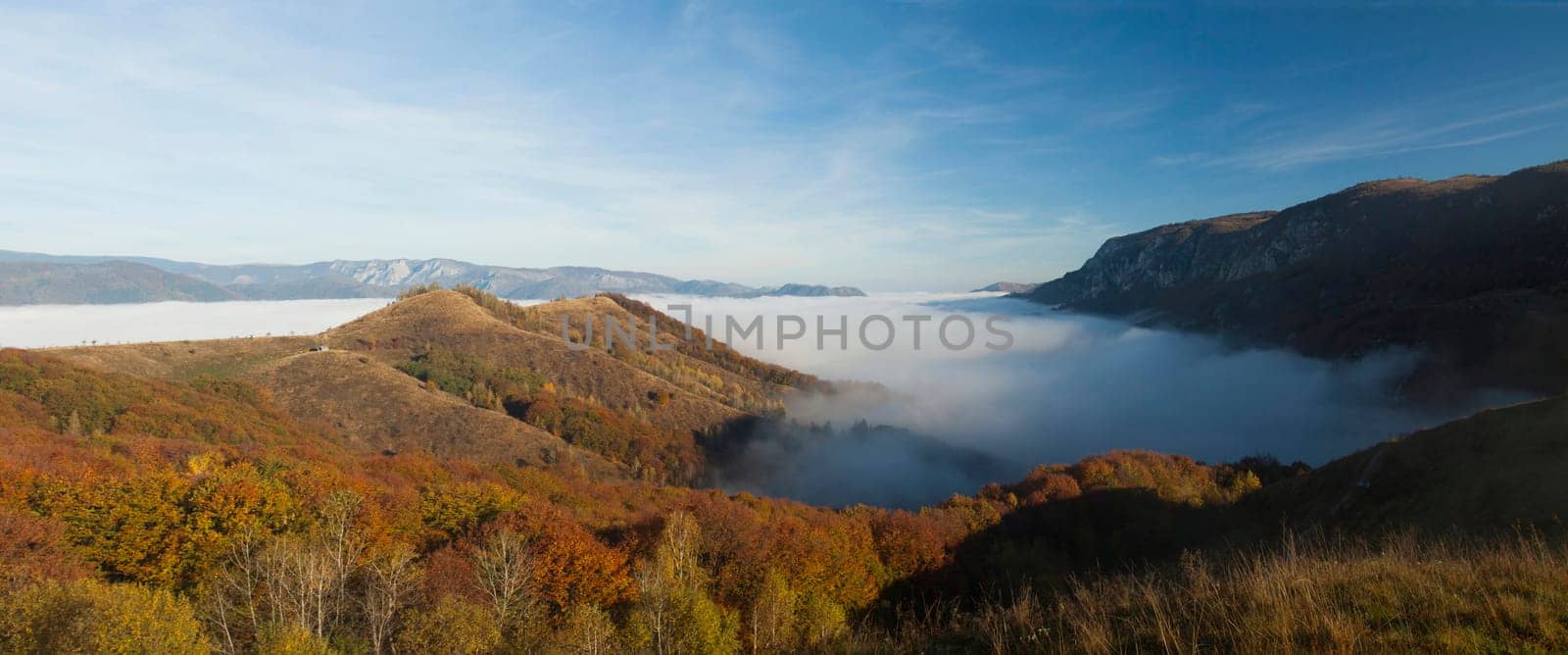 Panoramic view of foggy autumn morning in the mountains