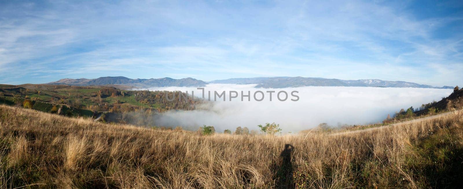 Panoramic view of foggy autumn morning in the mountains