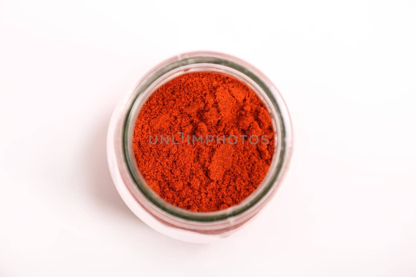 Paprika powder in a glass pot.