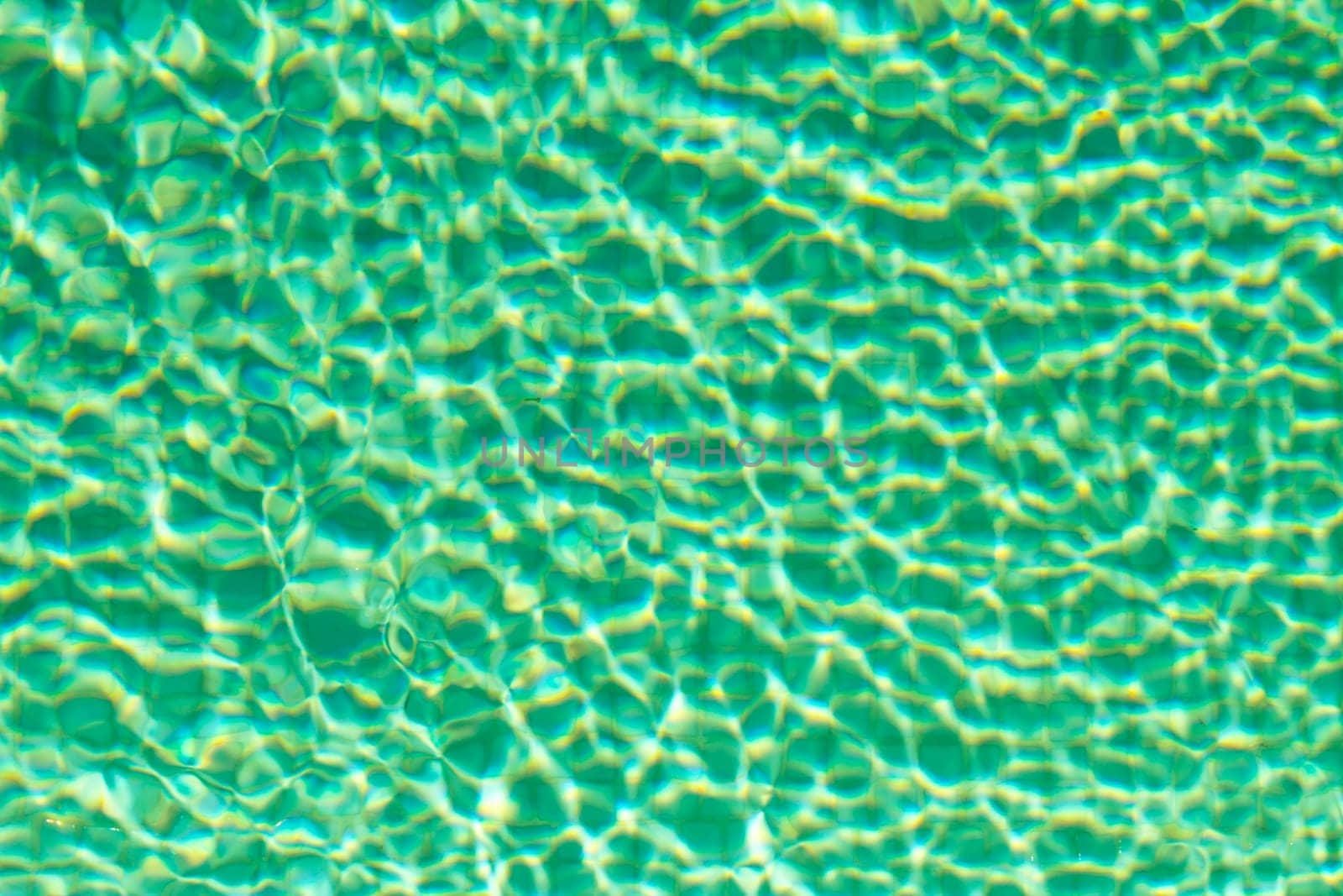 Water on a tiled swimming pool background.