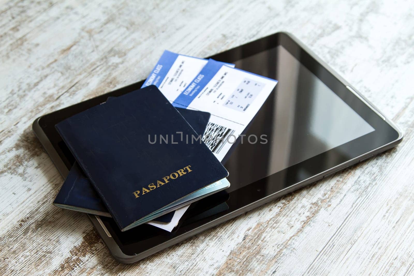 Airline tickets over the keyboard of a laptop.