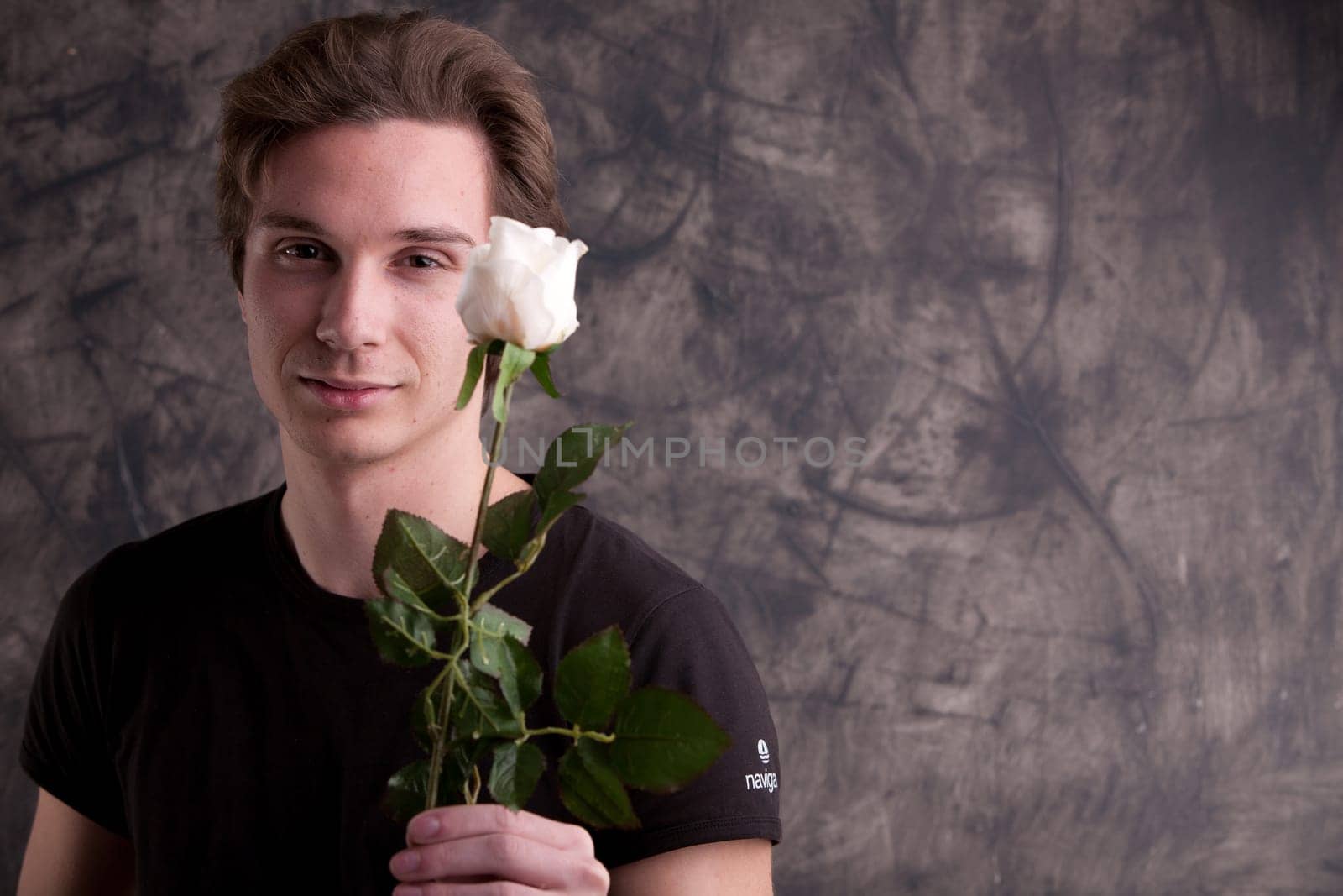 boyfriend giving a white rose to his girlfriend