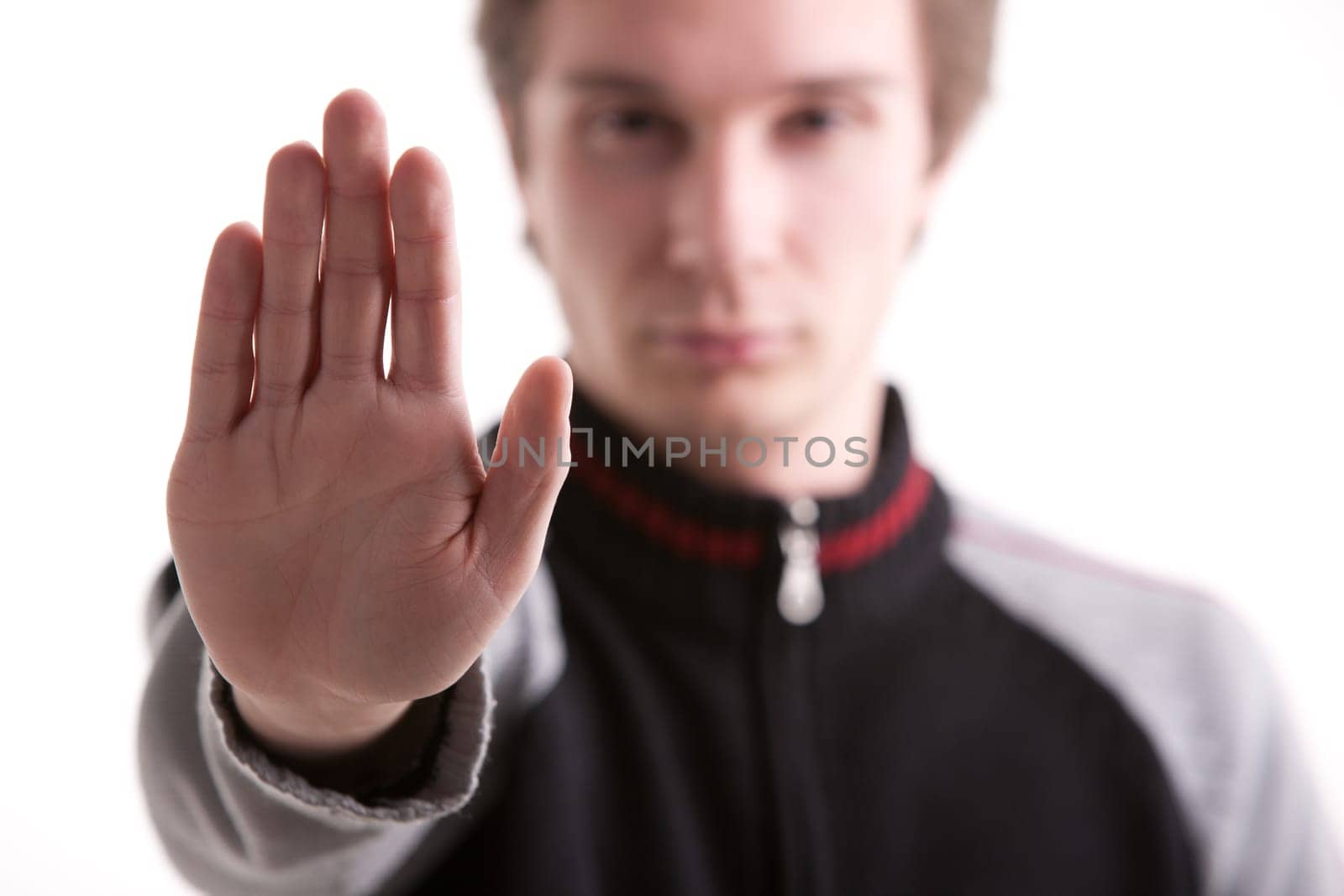 young man pushing out his hand meaning no entry