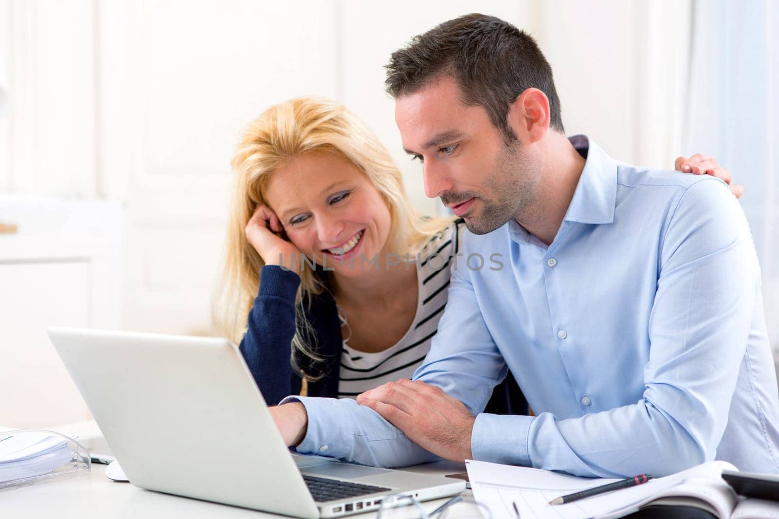 View of a Young attractive couple using laptop at home