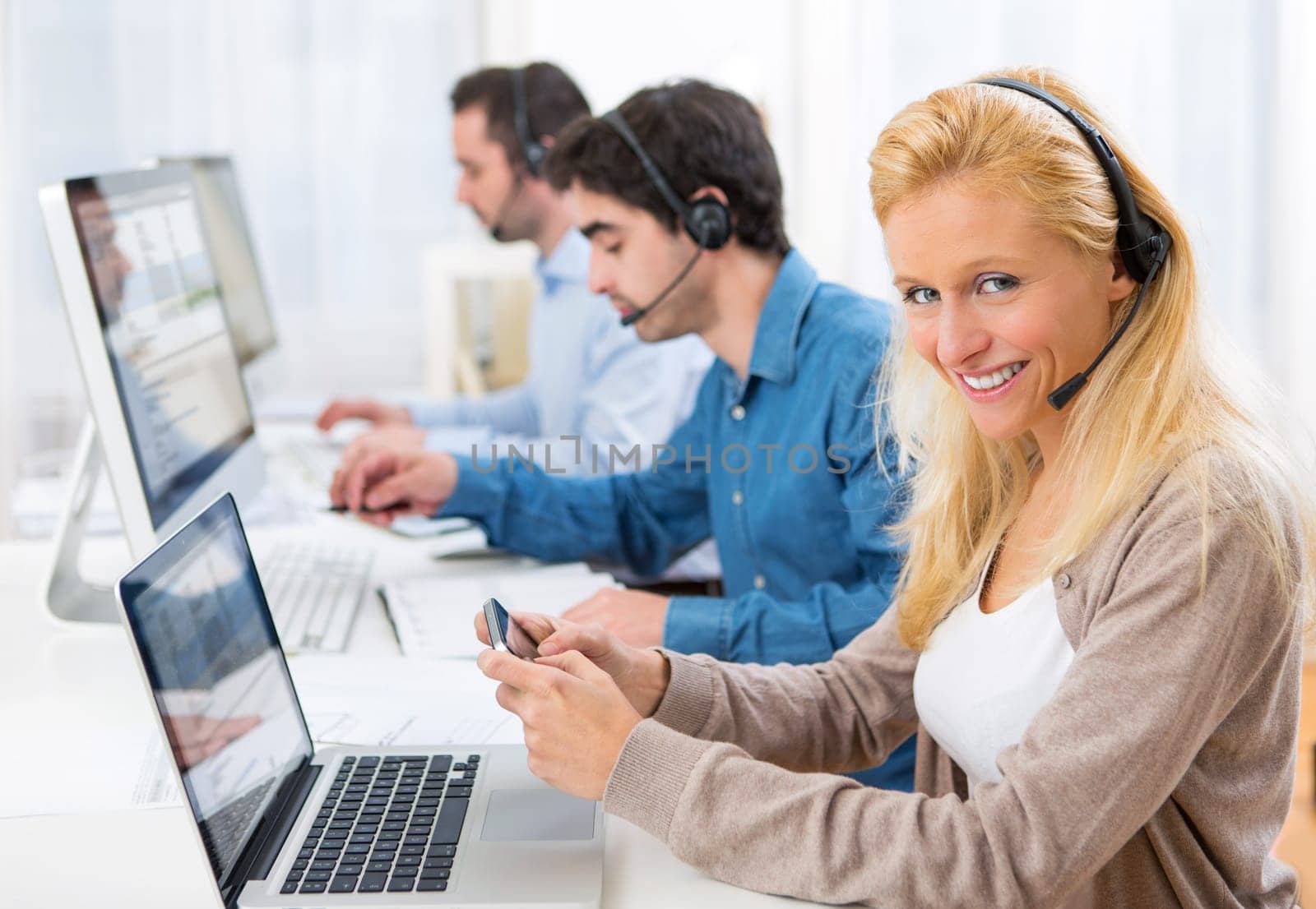 View of a Young attractive woman sending text at work