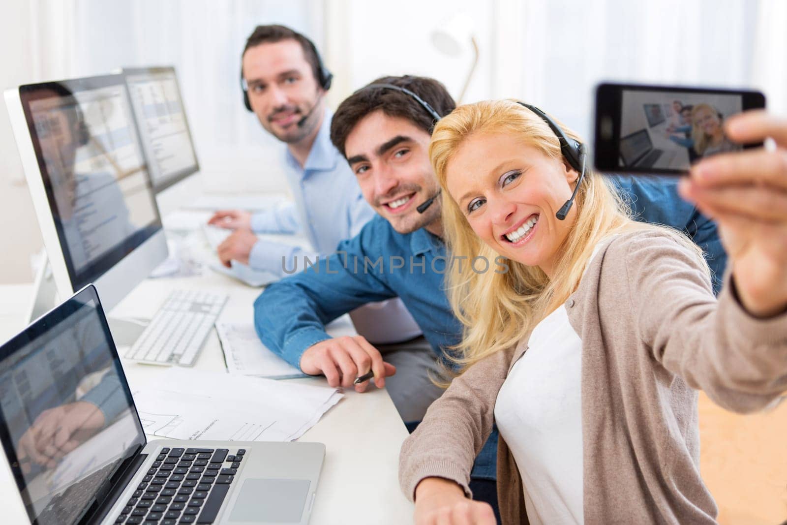 View of a Woman doing selfie with her colleagues