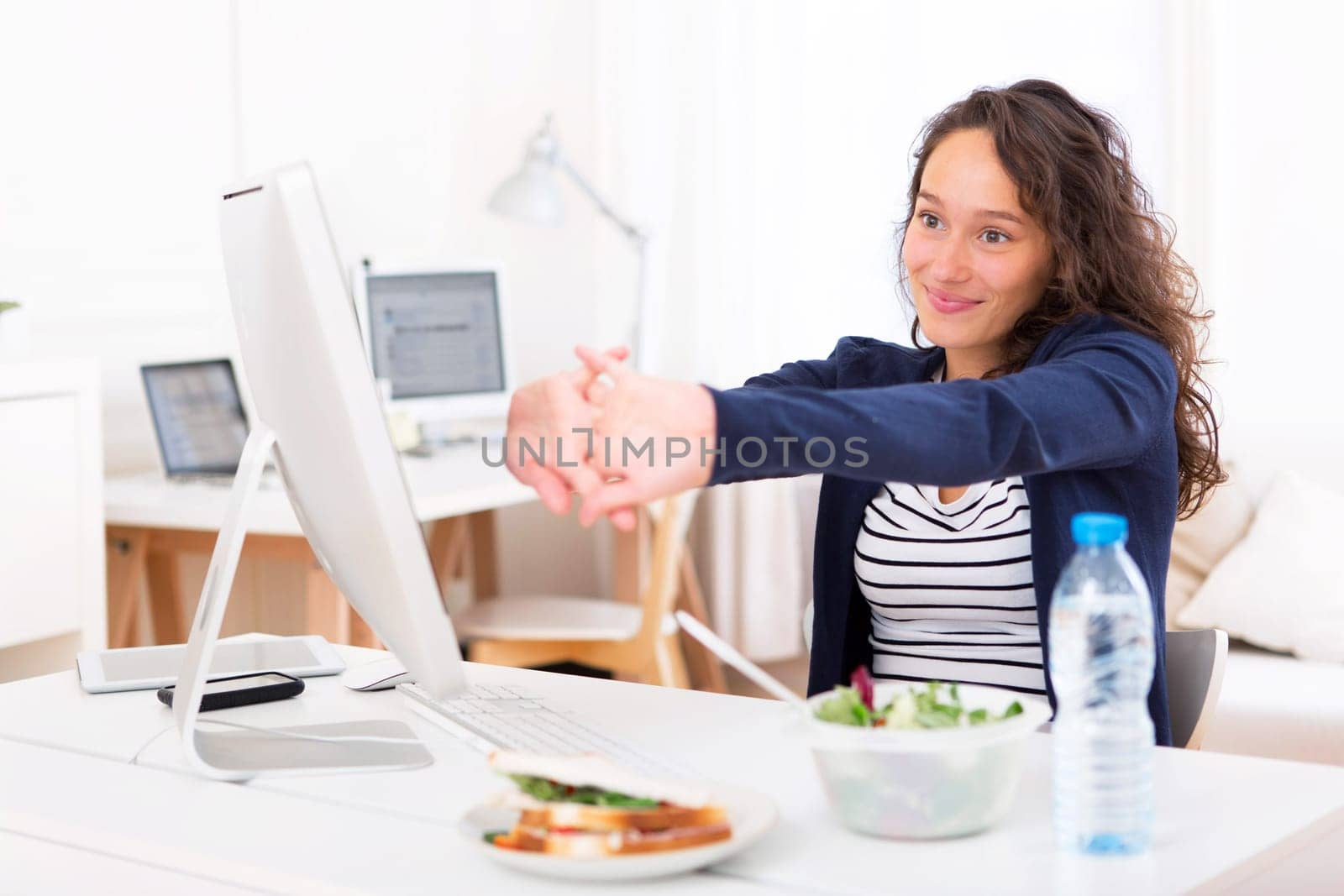 View of a Young attractive woman stretching during a meal break