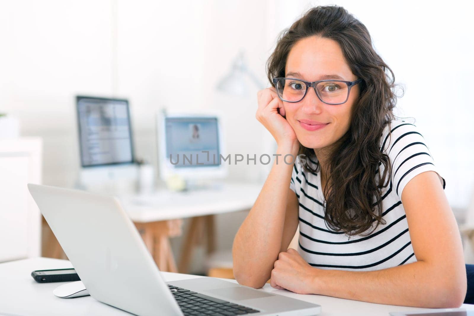 View of a Young attractive student woman working at home