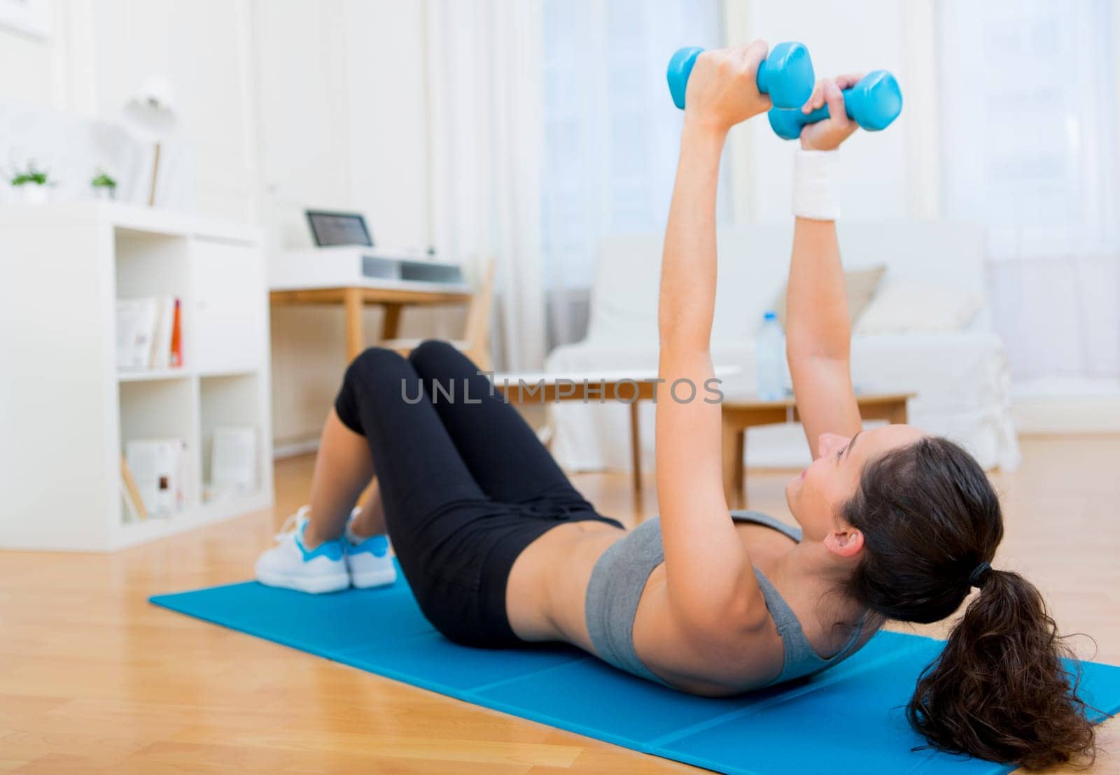 view of a Young attractive girl doing exercise at home
