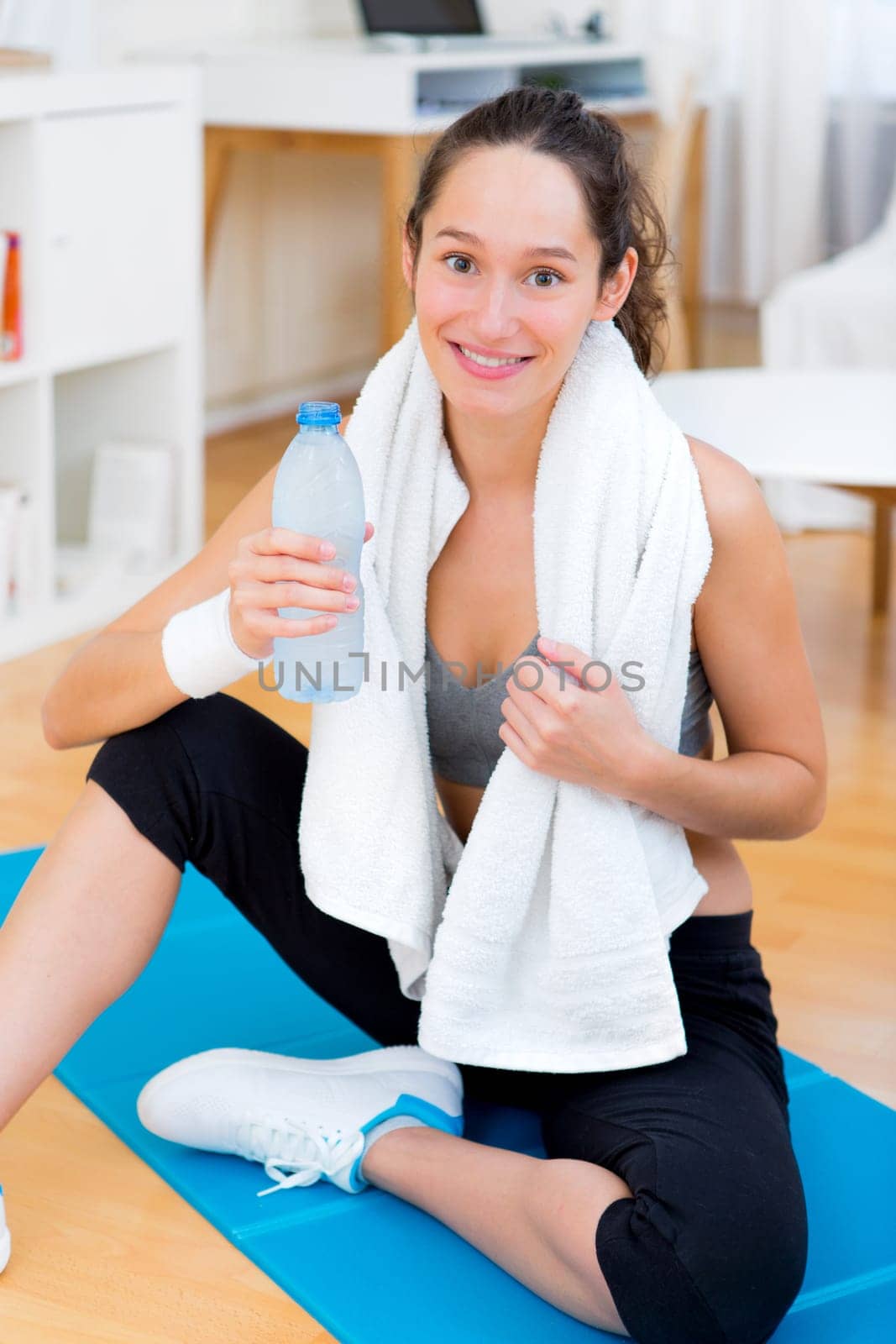 View of a Woman drinking water after a sport session