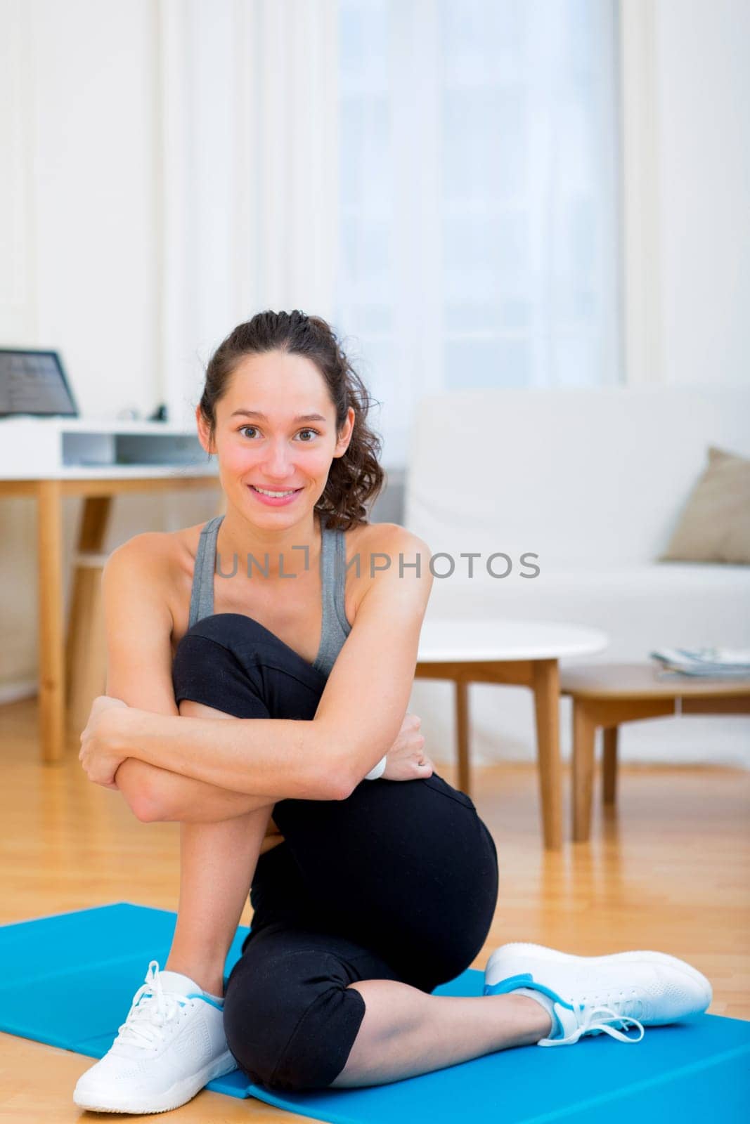 View of a Young attractive woman stretching after sport