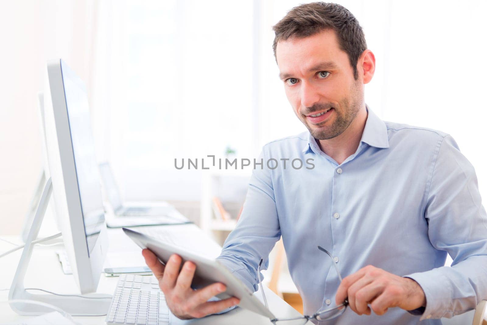 View of a Young attractive man with tablet at the office