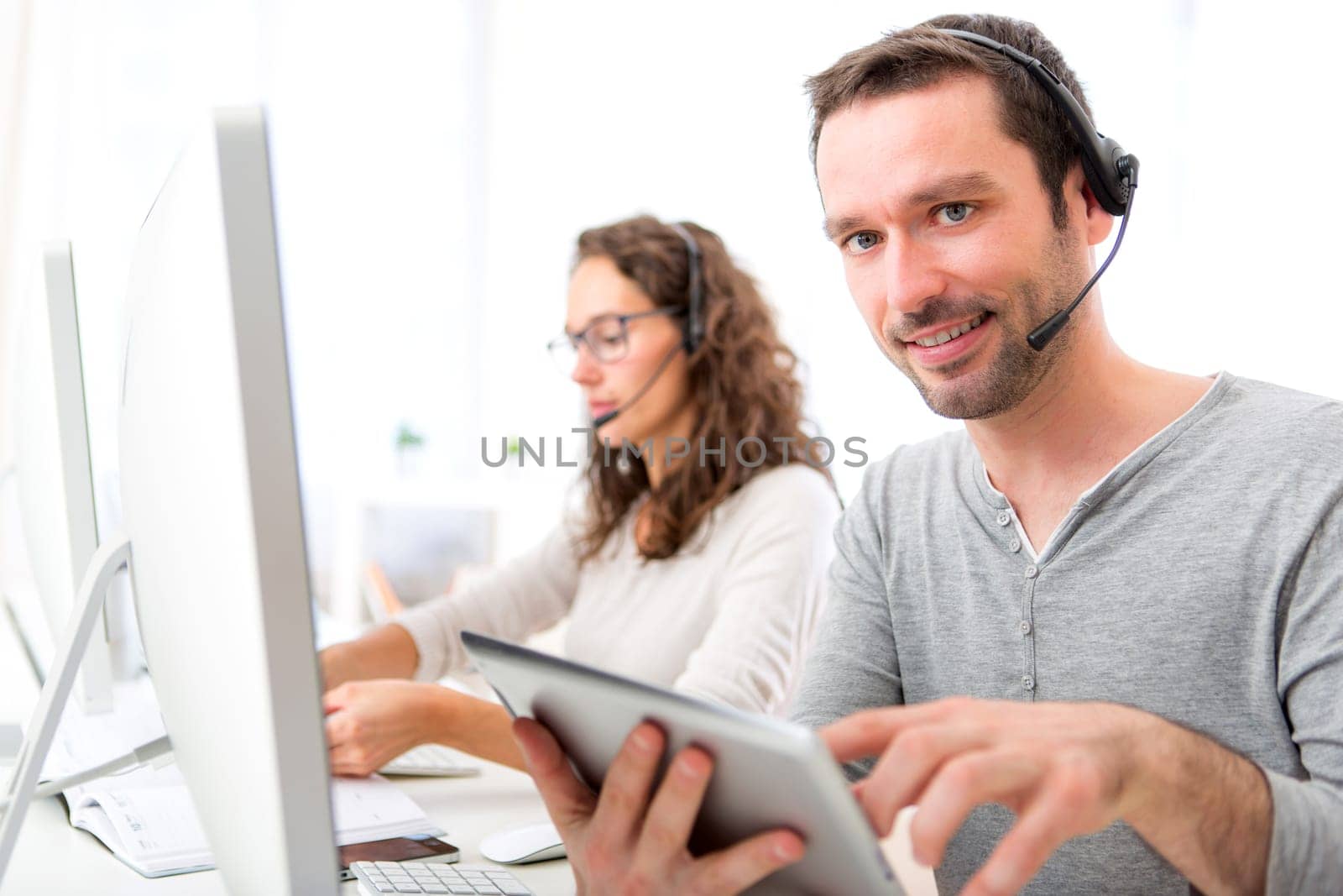 View of a Young attractive man working in a call center