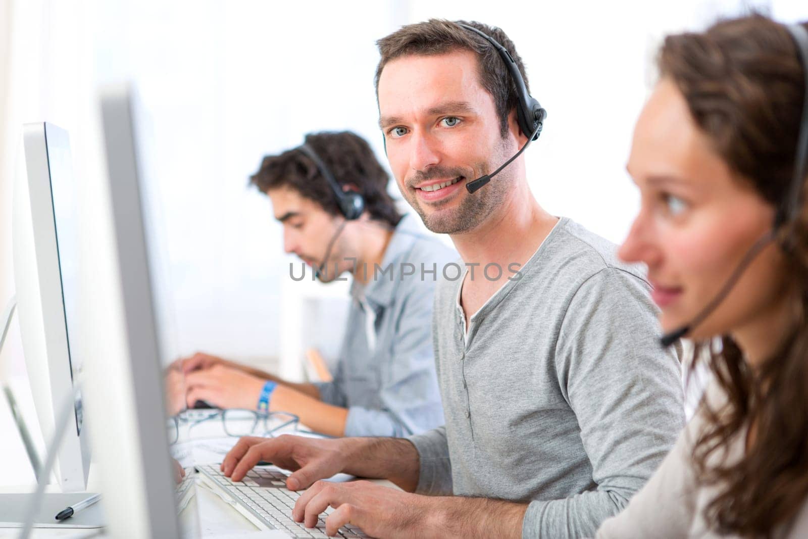 View of a Young attractive man working in a call center