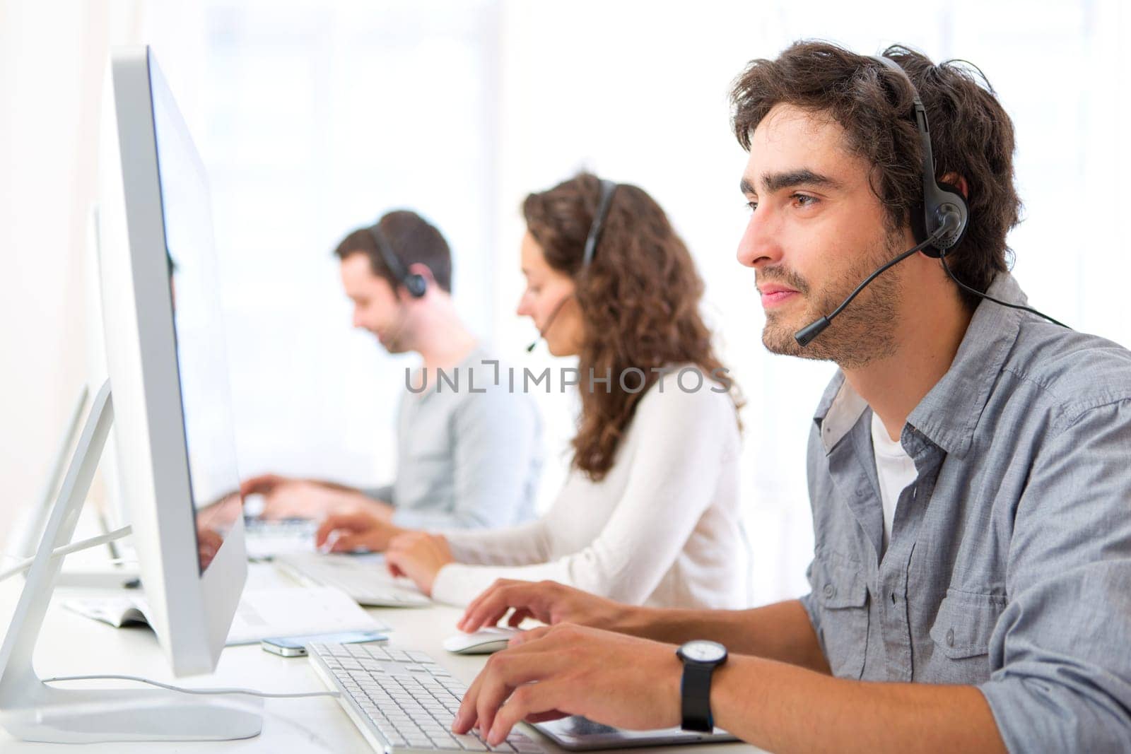 View of a Young attractive man working in a call center