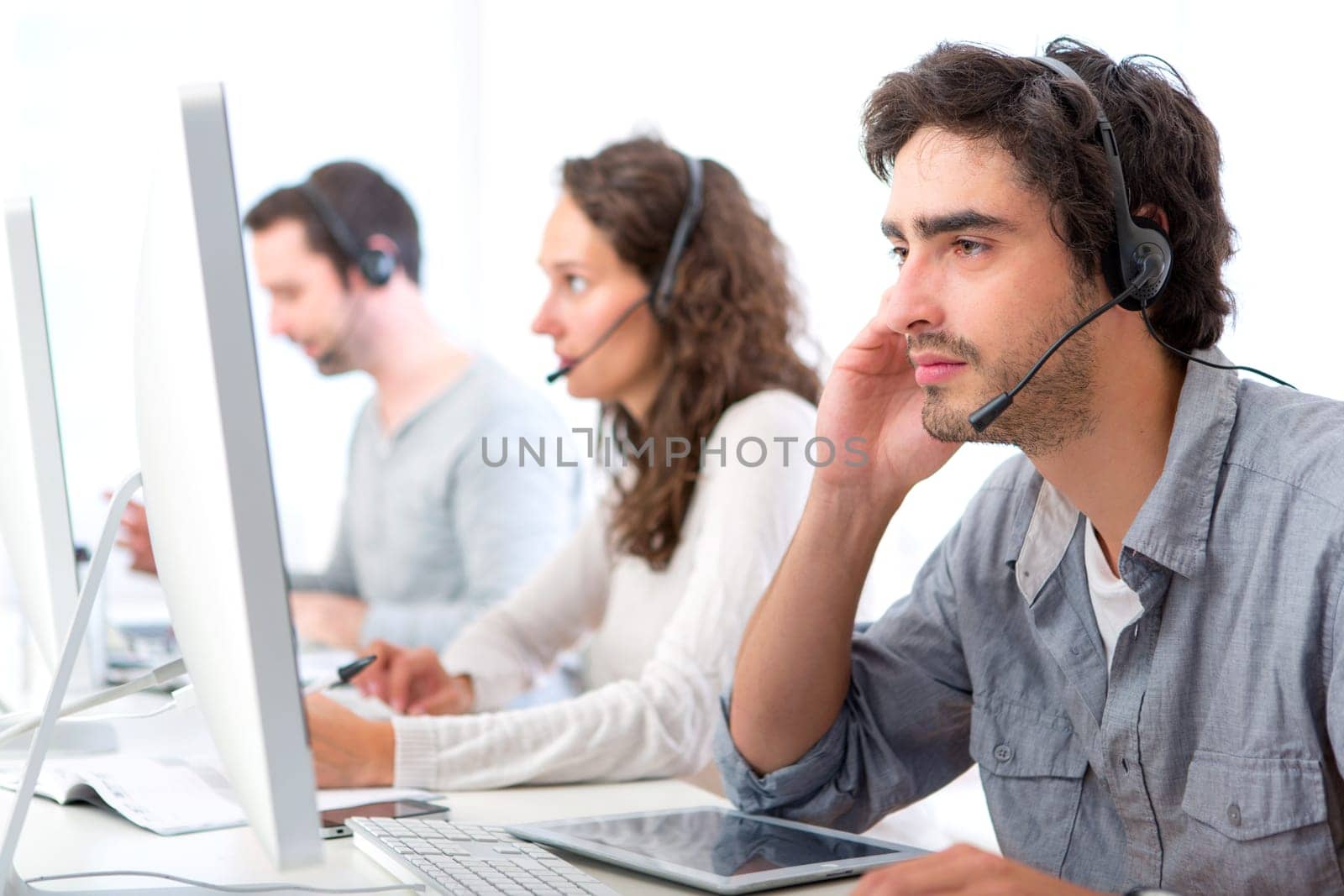 View of a Young attractive man working in a call center