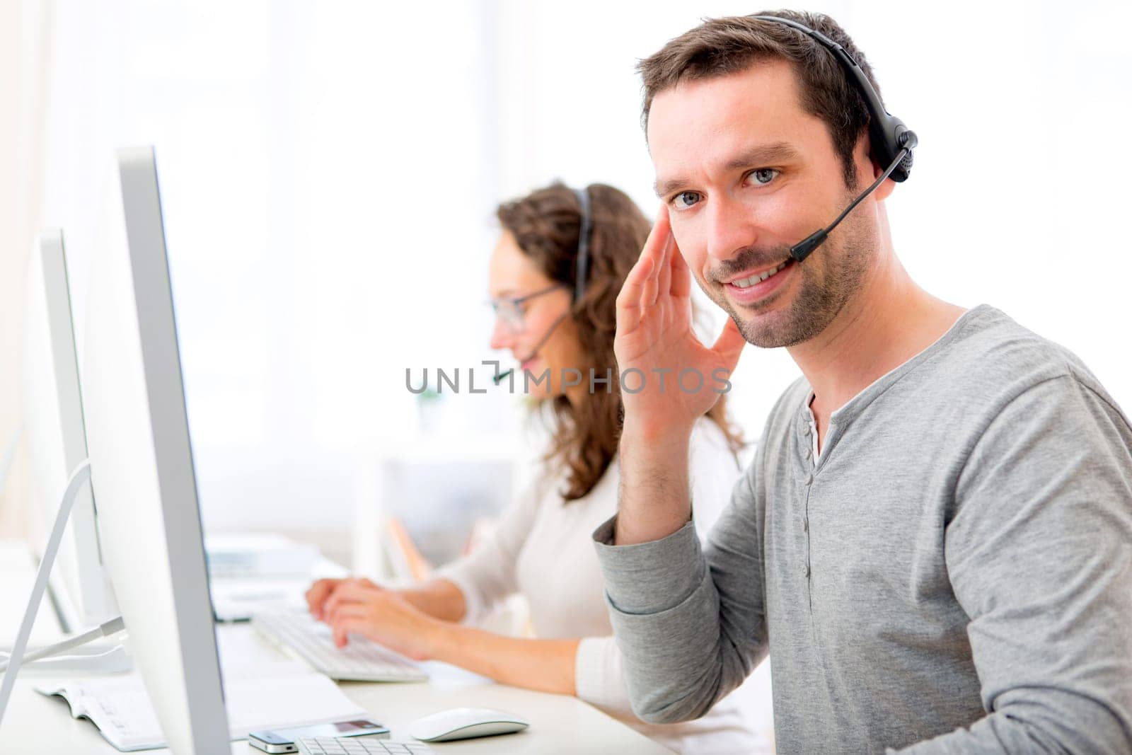 View of a Young attractive man working in a call center