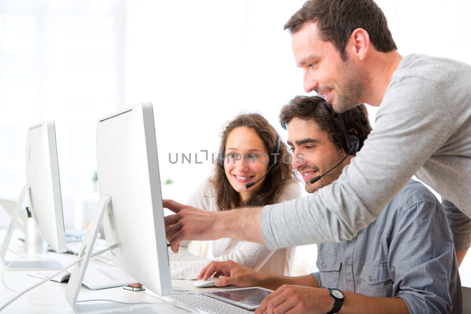 View of a Group of people working around a computer
