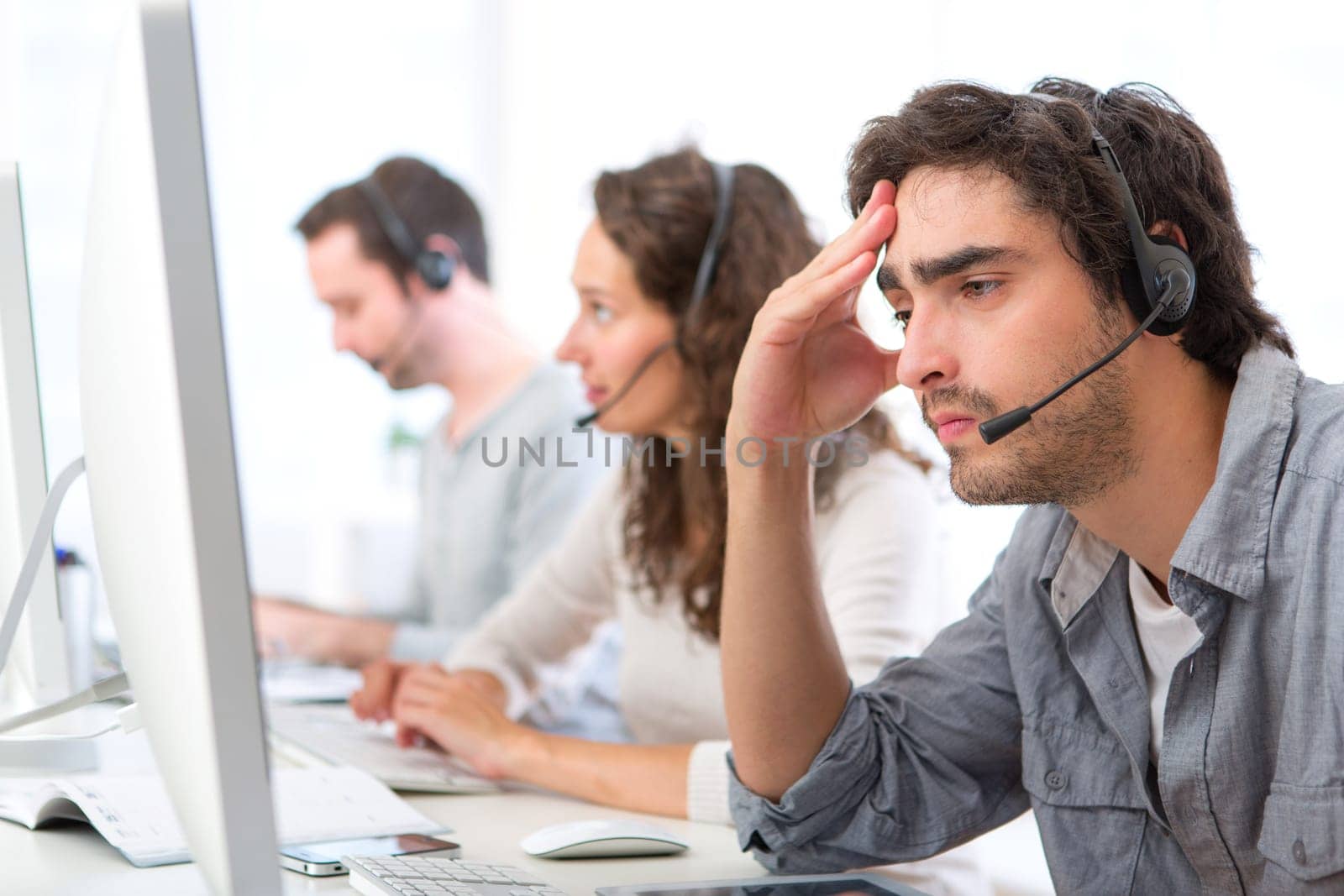 View of a Young attractive man ill-at-ease at work