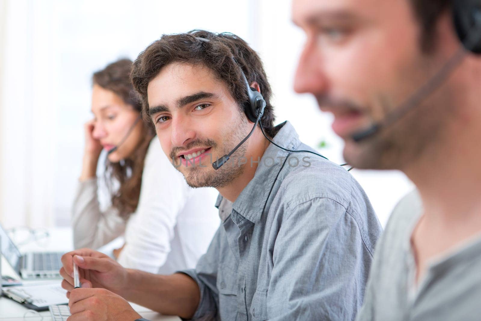 View of a Young attractive man working in a call center