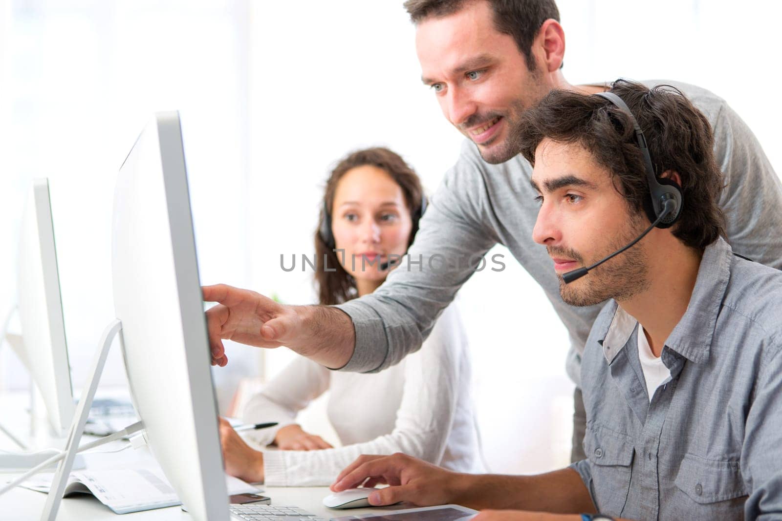View of a Group of people working around a computer