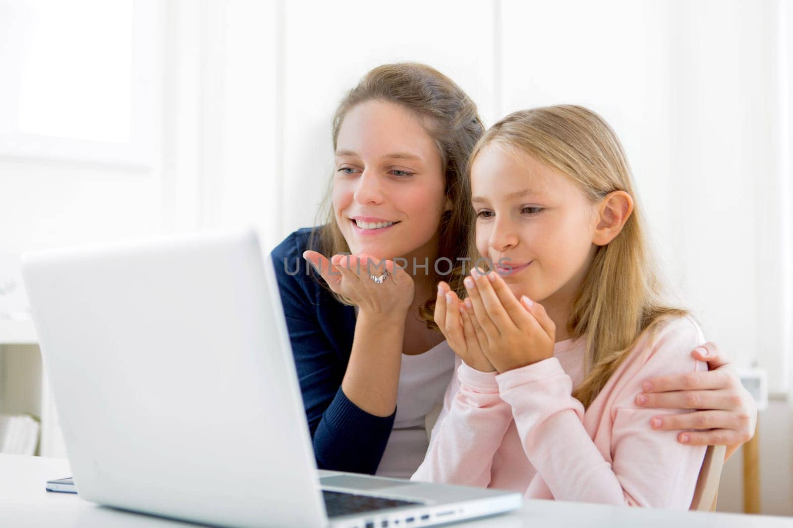 View of an Attractive woman and little sister videocalling