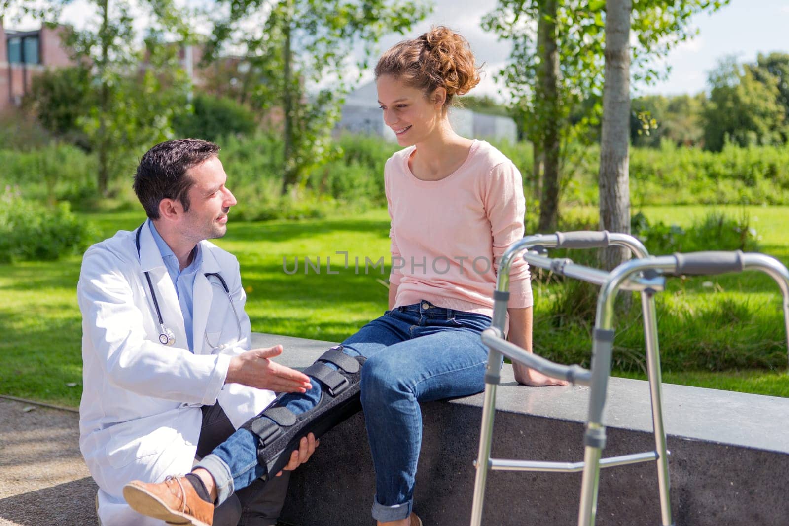 View of a Doctor helping a young woman during reeducation