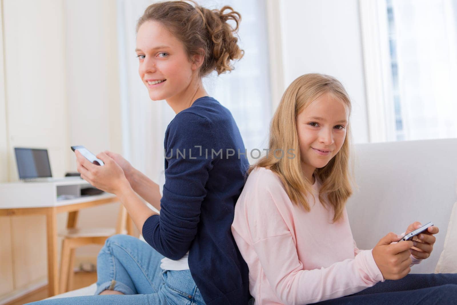 View of an Attractive woman and little sister using mobile